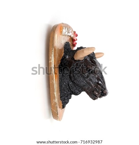 Magnetic souvenir from Malaga (Spain) isolated on white background. Head of a bull