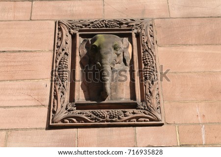Sandstone elephant relief on an English civic building. A carved elephant made of sandstone from the exterior of an English civic building.