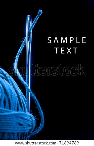 Metal needle and string. Very much a close up. Black background. Royalty-Free Stock Photo #71694769