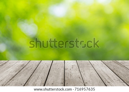 Wood plank with abstract natural green blurred bokeh background for product display