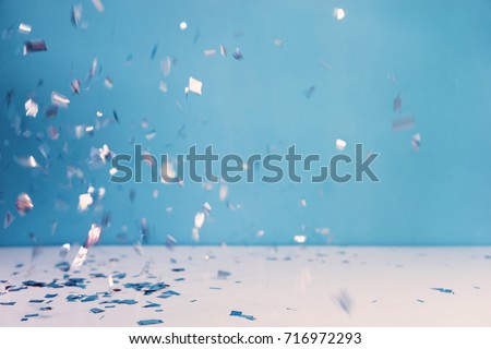Confetti party on blue background. Celebration concept.