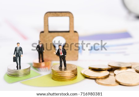 Key to succeed big market share,miniature business people stand on golden coins with graph chart background