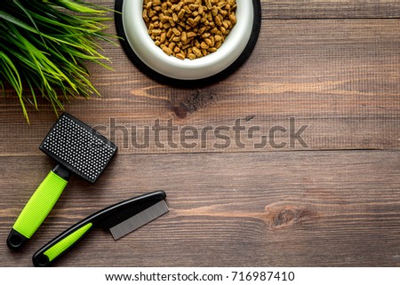care about pet with brushes and grooming equipment on wooden background top view mockup