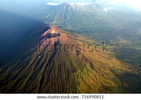 Mount Agung view from an air plane Window. Mount Agung is one of two active volcano in Bali Indonesia. Royalty-Free Stock Photo #716990815