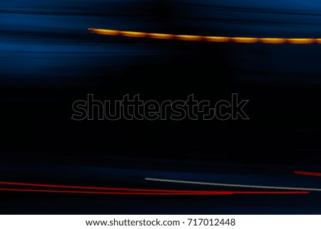 Abstract motion blur of multicolor night light on a black background.
