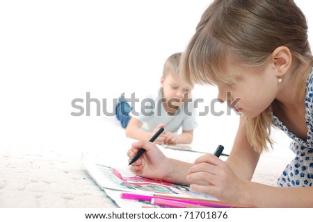 5 year old kids drawing and reading lying on the floor
