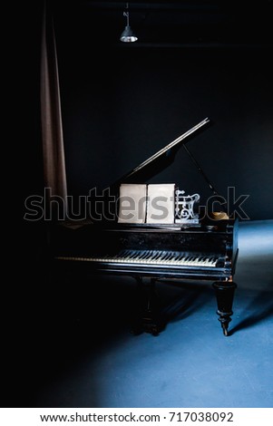 Black piano in a dark room