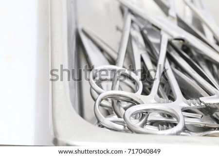 Soft focus on Operation room concept : many used operation scissors in stainless tray waiting for sterilizing system , copy space composition