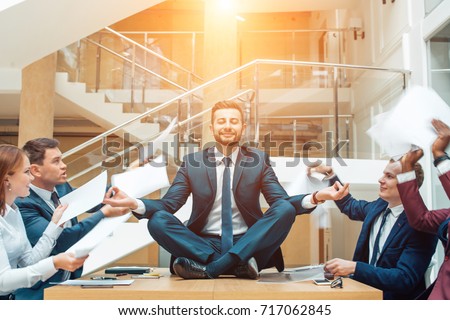 Business negotiation, male partners arguing, funny easygoing man keeping calm in stressing situation, meditating with composed smile, dealing with emotional angry customer, stress management concept Royalty-Free Stock Photo #717062845