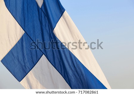 Finnish flag under a blue sky. Finland symbol. Europe. Horizontal