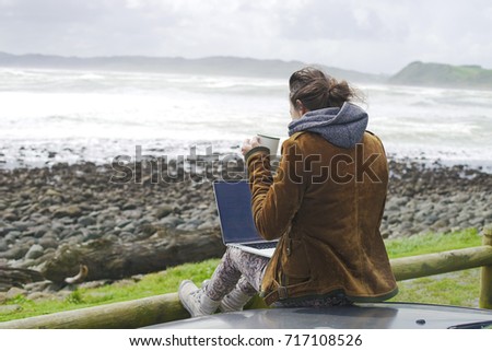 Girl working on Laptop at the beach