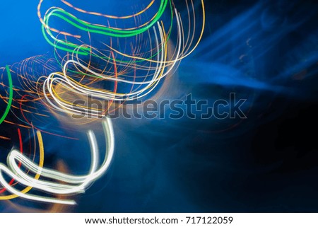 Abstract motion blur of multicolor night light on a black background.