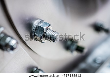 Bolted screw connection, sealing connection. Abstract industrial background Royalty-Free Stock Photo #717135613