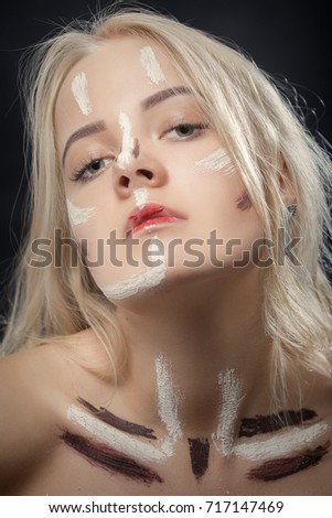 female portrait with professional face art paint cosmetics