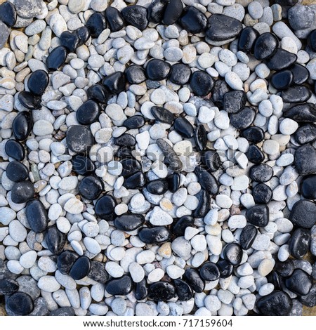 Sequence of black and white stones laid out in the form of a spiral