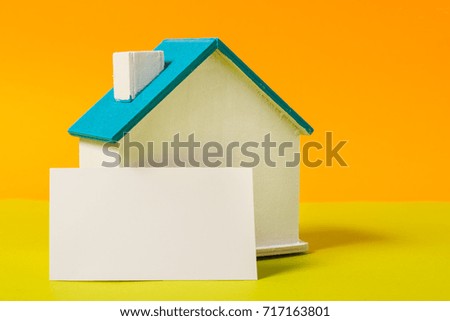 Miniature wooden house, symbol, with business card