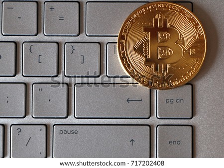 Bitcoin close-up on keyboard background.