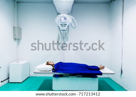 Asian young sick lady sleep on a Scan bed and panel control by Radiologic technician health concept