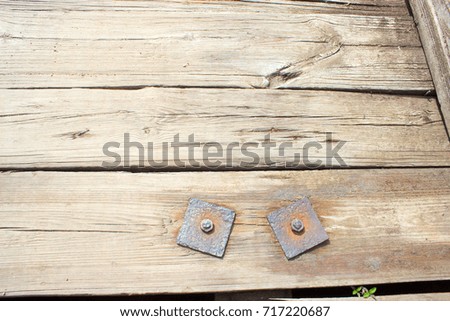 Rusty bolts with washers - a component of a wooden bridge.