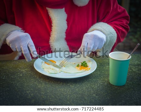 Breakfast of Santa Claus with fried egg in the garden.Christmas. Morning Royalty-Free Stock Photo #717224485