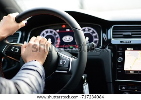 Woman pushing horn while driving Royalty-Free Stock Photo #717234064