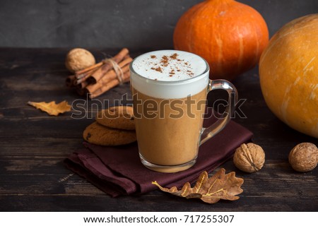 Pumpkin Spice Latte. Cup of Latte with Seasonal Autumn Spices, Cookies and Fall Decor. Traditional Coffee Drink for Autumn Holidays.