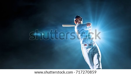 Baseball male player performs a dramatic play on the dark background. He wears unbranded sport clothes. The background is made in 3D.