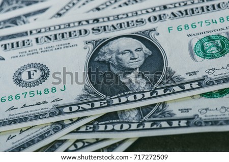 One dollar banknotes on a black table. Cash money american dollars. Vintage background. Lens flare. American currency.
