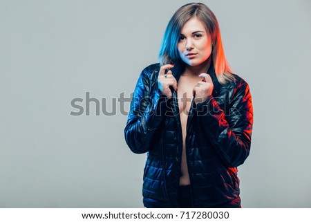Young beautiful cute girl showing different emotions. Background for the girl a concrete gray wall. Laughing, smiling, anger, suspicion, fear, surprise.