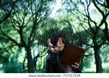Picture of witch with outstretched hand and book