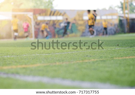 Picture of football match with shallow depth of field. Focus on foreground.