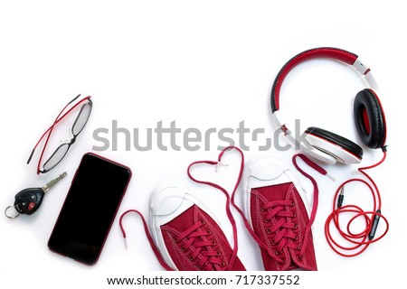 Sneaker shoes , mobile phone and other  accessories such as headphone , car key and eyeglass on white background , top view and copy space Royalty-Free Stock Photo #717337552