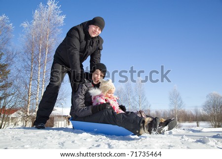 Happy family sledding