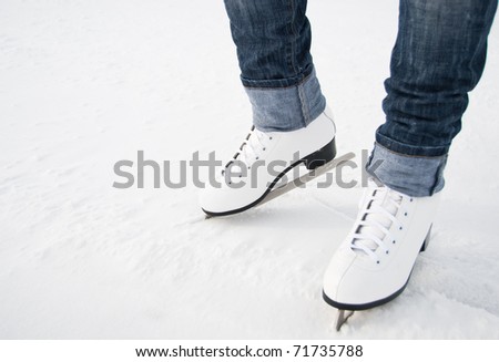 woman legs in white ice skates