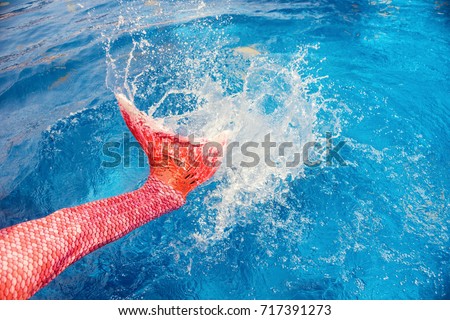 Mermaid tail water splash in swimming pool. Vacation, fun background. Text space