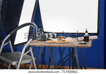 Photo studio with professional lighting equipment and camera for shooting food