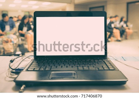 Laptop with blank screen on table in Meeting room , Vintage effect tone.