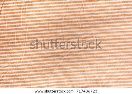 The orange and white color pattern of bed sheet cloth, background texture
