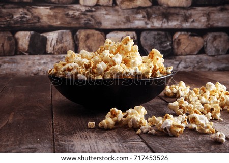 Salt popcorn or sweet popcorn in bowl on the wooden table