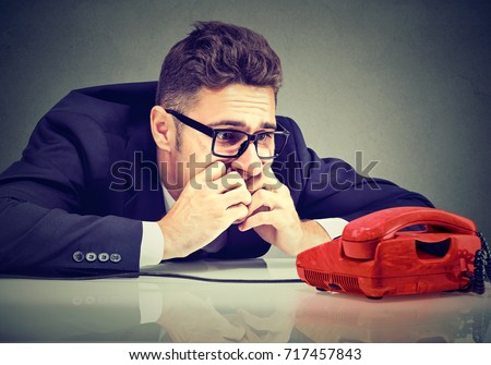 Desperate man waiting for someone to call him 
