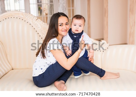Close up of mother holding newborn baby in arms