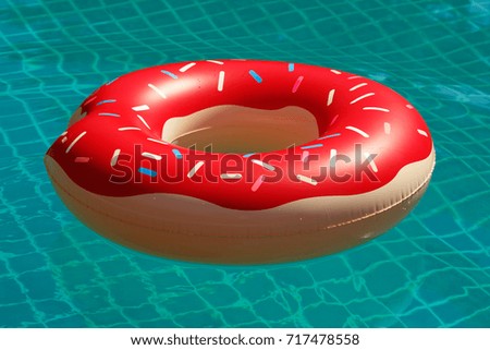 Inflatable swim ring in shape of a donut in the pool