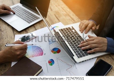 couple smart businessman doing financial and marketing chart report with laptop and document in meeting room. well done negotiating outstanding business. Royalty-Free Stock Photo #717479551