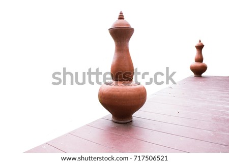 An ancient pitcher placed on a wooden floor on a beautiful white background suitable for the design.