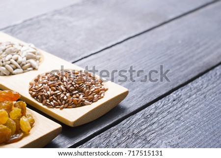 lin seeds, black wooden table background