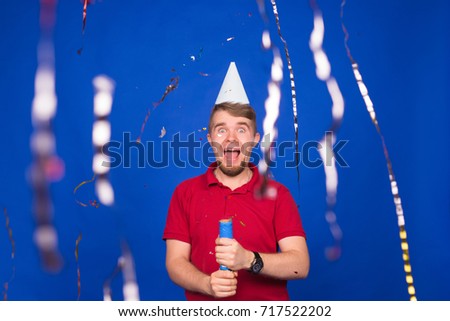Young funny man with confetti. Holidays, carnival, christmas and new year party concept