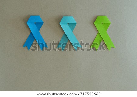 Prostate, colon and lymphoma cancer strips made of paper with beige background.