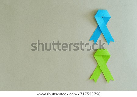 Duo of cancer colon and lymphoma strips made of paper on beige background.
