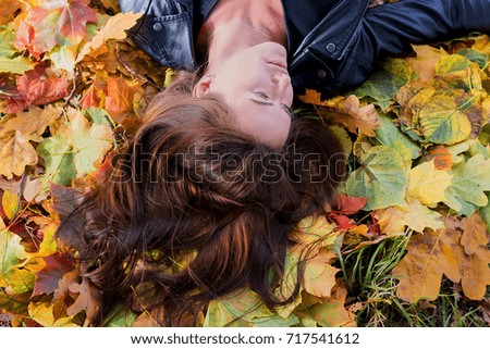 beautiful girl in autumn leaves