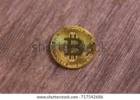 Golden bitcoin on wooden background. Crypto currency, virtual money, internet and economics concept
